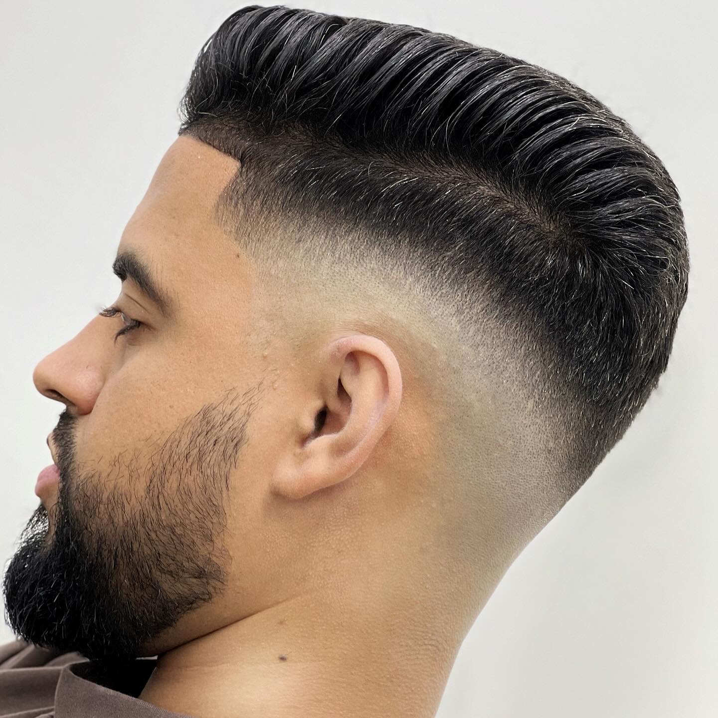 Slicked-back fade with beard detail at Ilverth Barber East Harlem