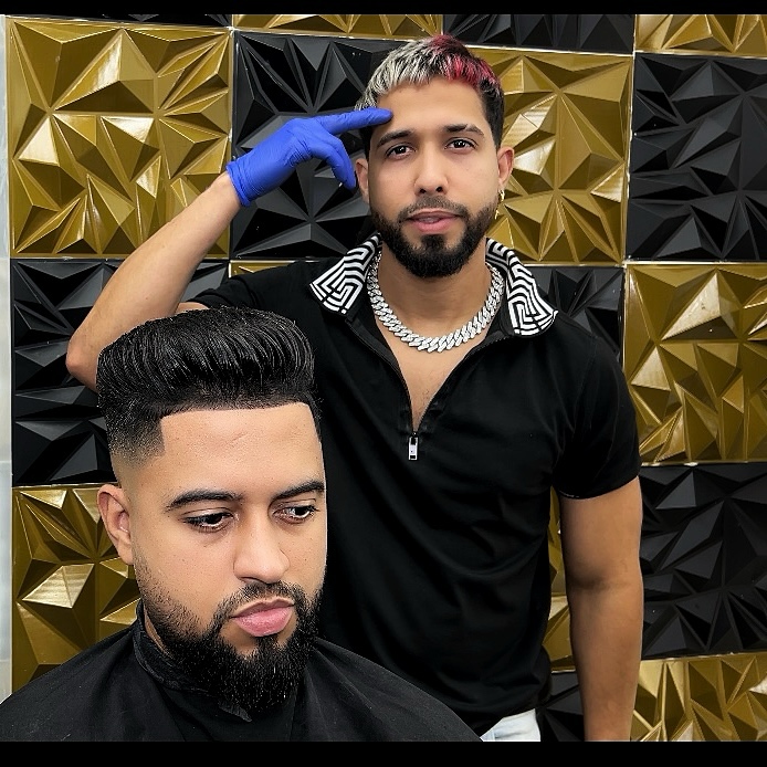 Ilverth Barber with a client showing a fresh cut, East Harlem NYC